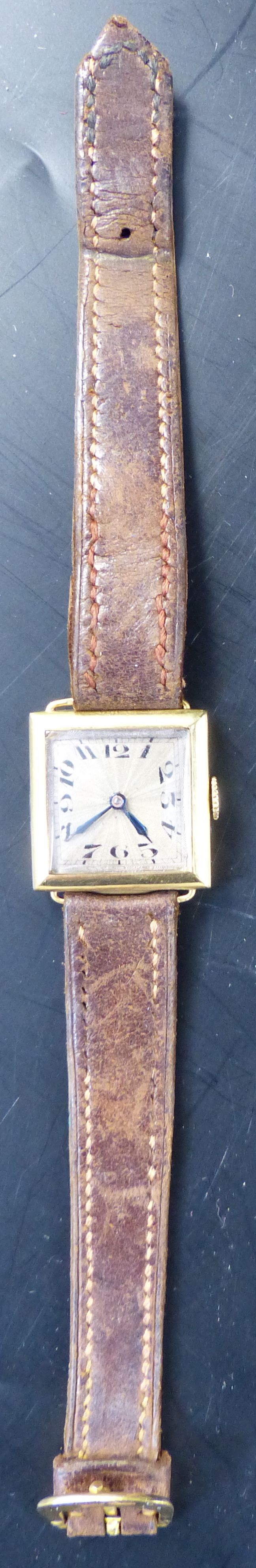 A ladys 1920s 18ct gold square dial wrist watch, 21mm, gross 14.8 grams and a Movado watch